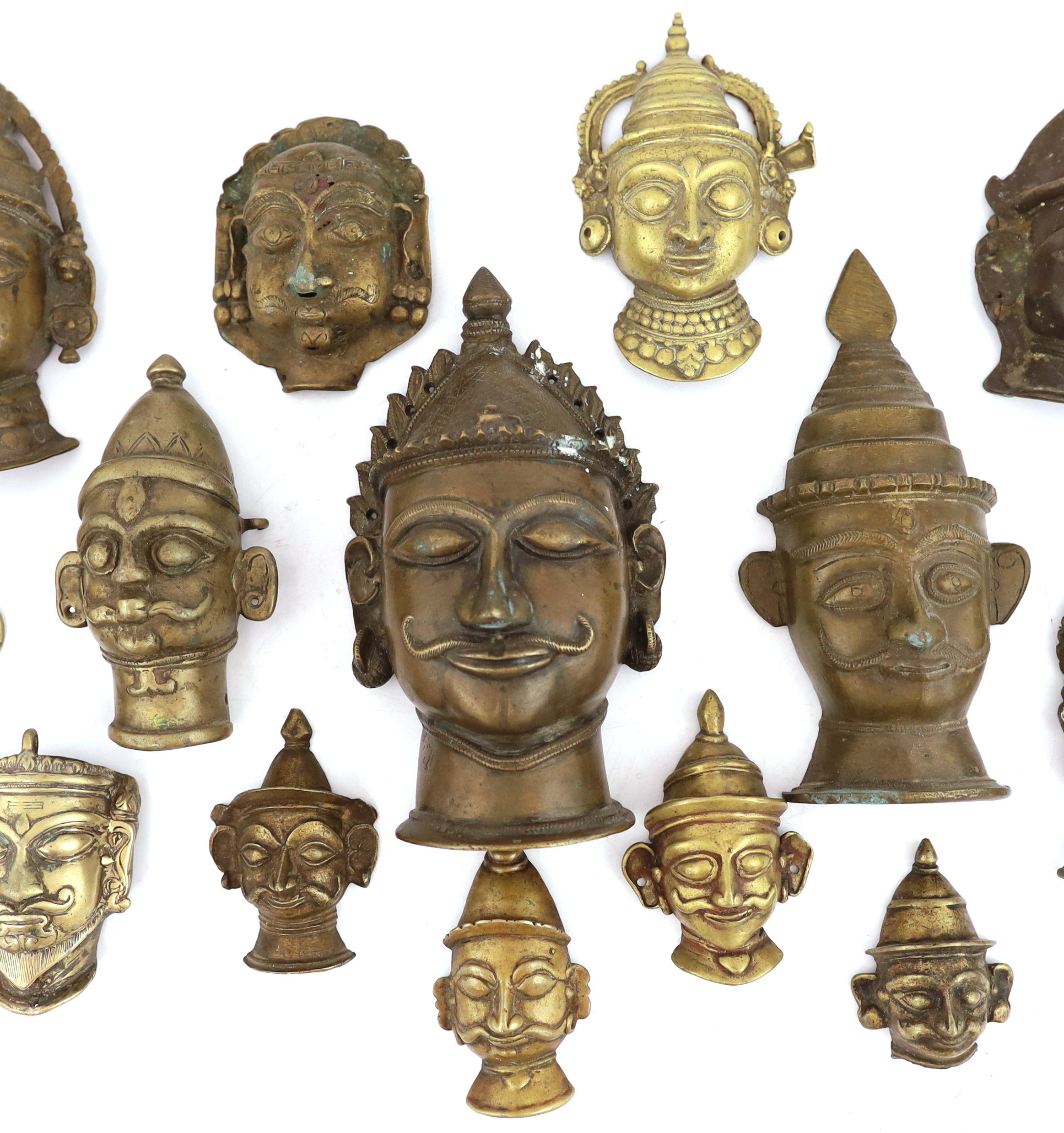 A group of nineteen bronze or brass Shiva masks, Southern India, 16th-19th century, 6.2 - 19.5cm high